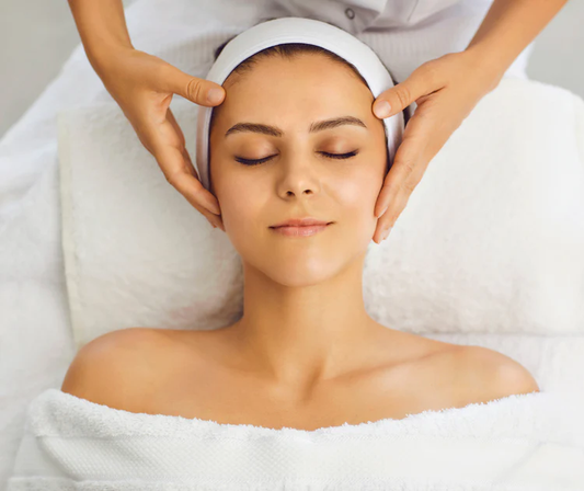 Woman receiving a head massage in a spa setting